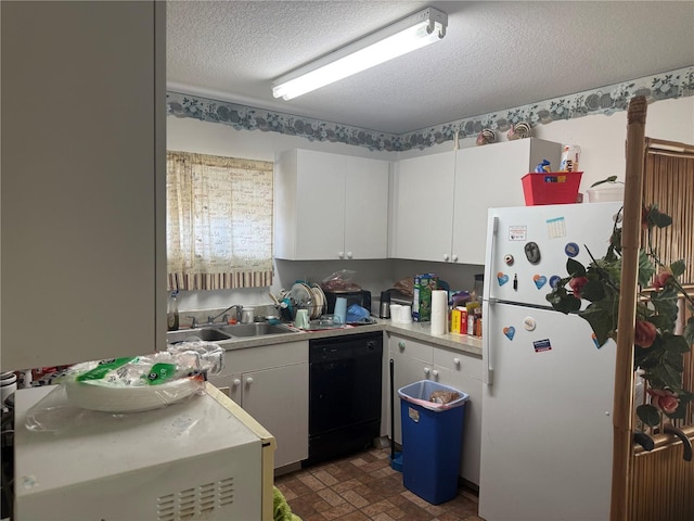 kitchen featuring a textured ceiling, sink, white refrigerator, black dishwasher, and white cabinetry