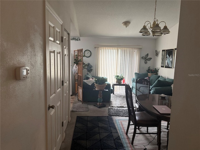 carpeted dining area featuring a chandelier