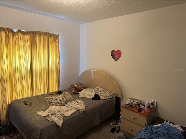 carpeted bedroom with a textured ceiling