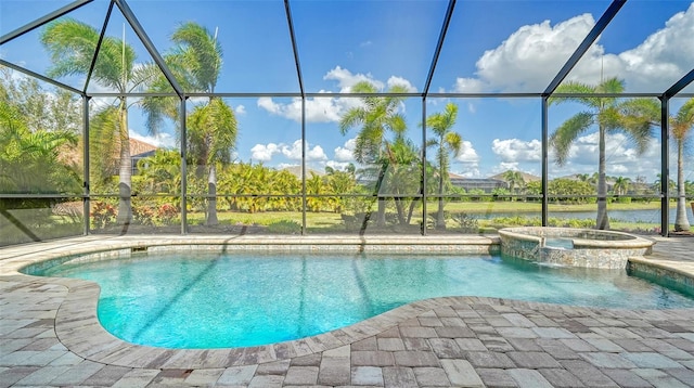 view of swimming pool with a patio area, glass enclosure, an in ground hot tub, and a water view