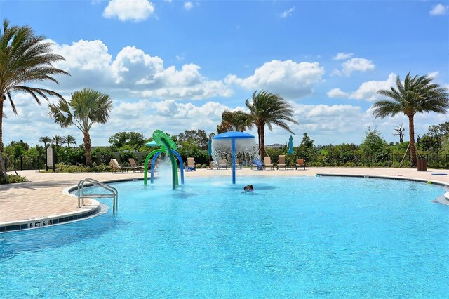 view of swimming pool featuring pool water feature