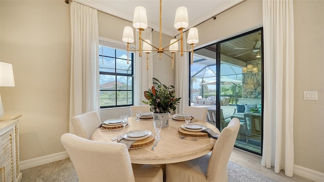 dining room featuring a notable chandelier, a wealth of natural light, and ornamental molding