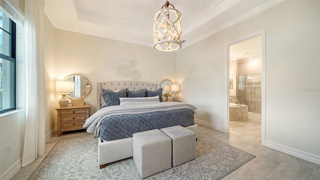 bedroom with a notable chandelier, ensuite bathroom, and a raised ceiling