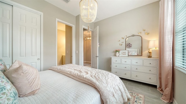 bedroom featuring a notable chandelier and a closet