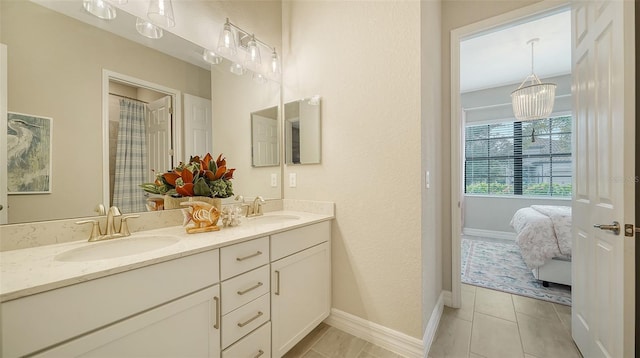 bathroom with tile patterned floors and vanity