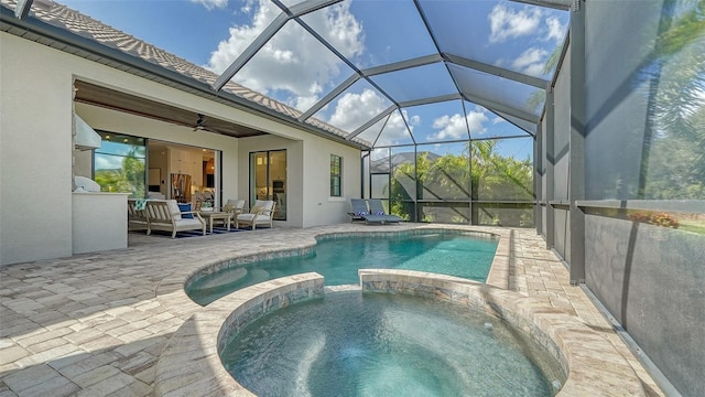 view of swimming pool featuring an outdoor living space, glass enclosure, ceiling fan, an in ground hot tub, and a patio