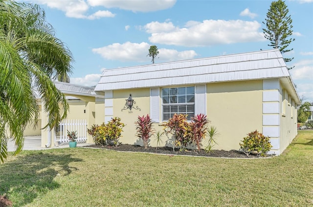 view of side of home featuring a yard