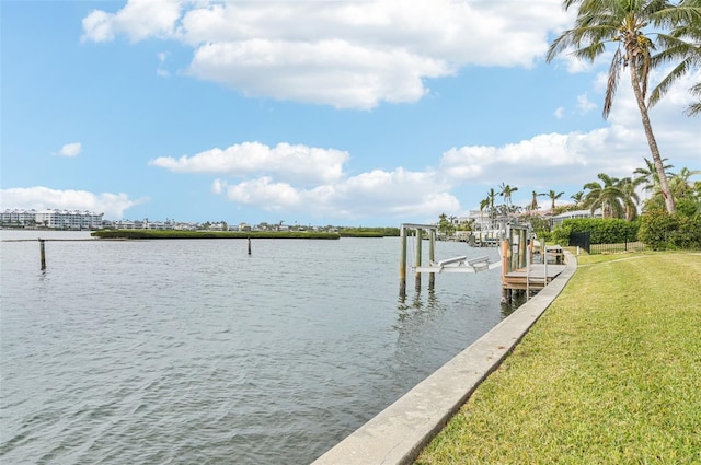 view of dock featuring a water view and a yard