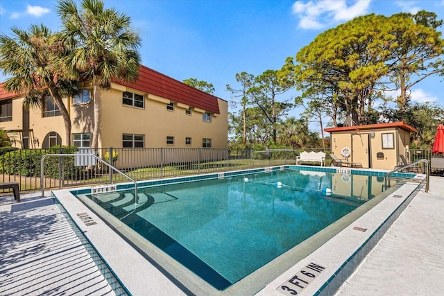 view of swimming pool featuring a storage unit