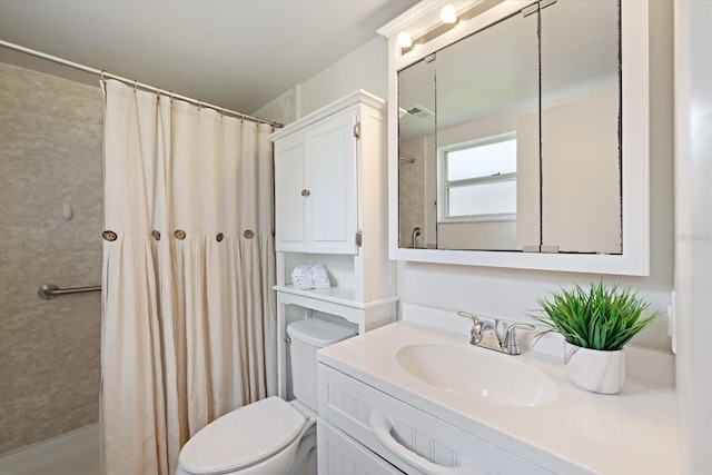 bathroom featuring curtained shower, vanity, and toilet