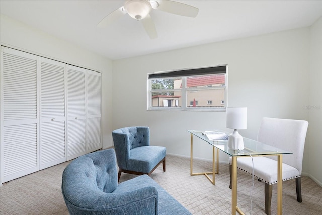 carpeted office featuring ceiling fan and baseboards