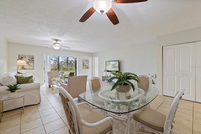 dining area featuring light tile patterned floors and a textured ceiling