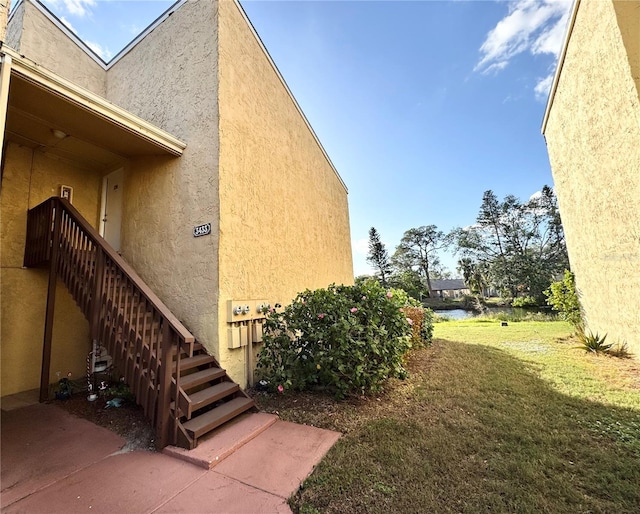 view of property exterior featuring a lawn