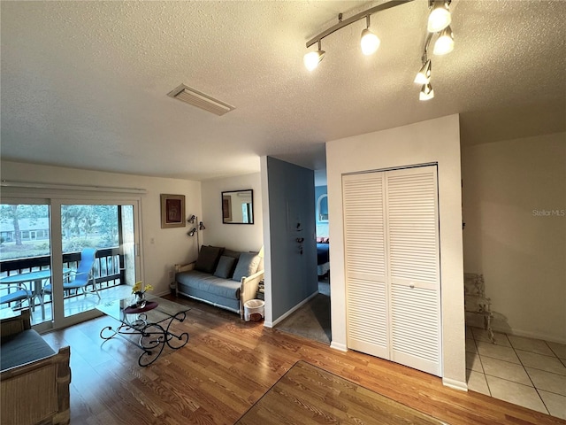 living room featuring hardwood / wood-style flooring and a textured ceiling