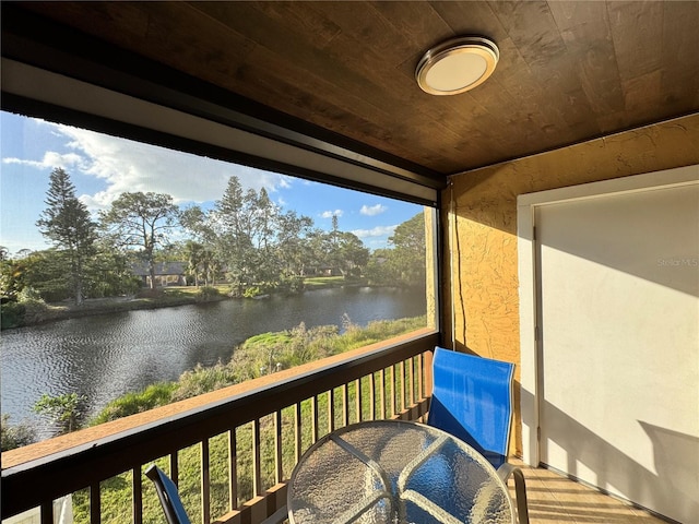 wooden terrace featuring a water view