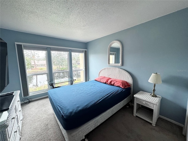 carpeted bedroom featuring a textured ceiling