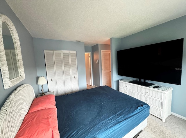 bedroom featuring carpet flooring and a textured ceiling