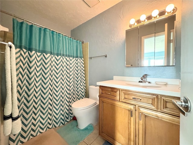 bathroom with a shower with curtain, tile patterned floors, a textured ceiling, toilet, and vanity