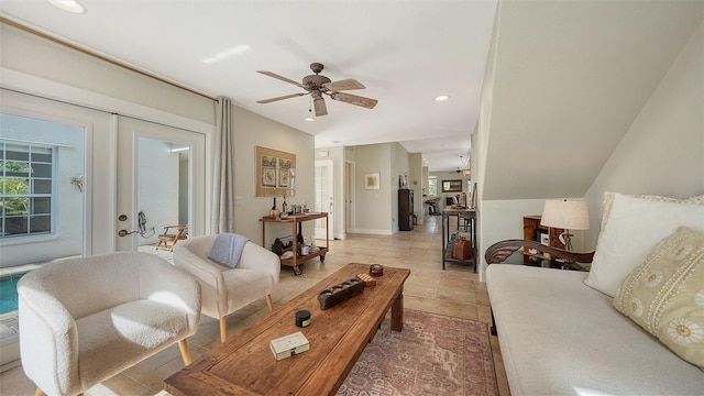 living room featuring ceiling fan, french doors, light tile patterned floors, and vaulted ceiling