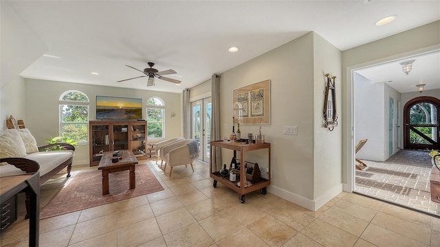 living room with ceiling fan, light tile patterned floors, and french doors