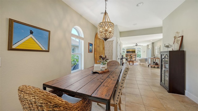 dining room with ceiling fan with notable chandelier and light tile patterned flooring