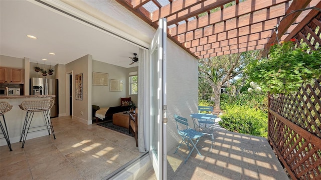 view of patio featuring ceiling fan, a pergola, and an outdoor bar