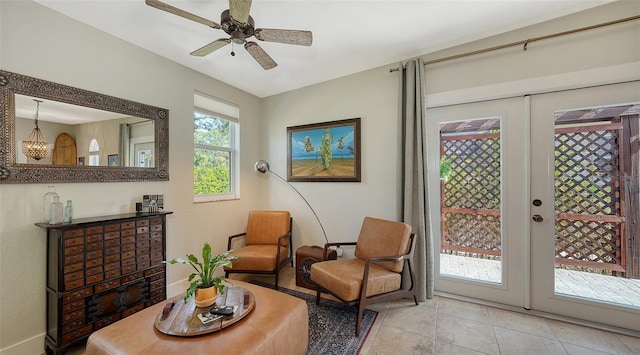 sitting room featuring ceiling fan, french doors, and light tile patterned floors