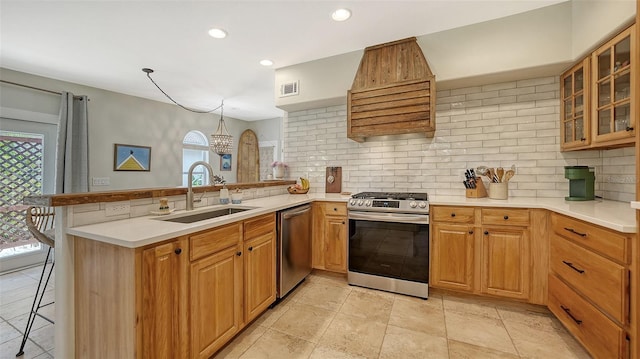 kitchen featuring backsplash, a kitchen breakfast bar, kitchen peninsula, and stainless steel appliances