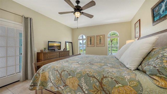 bedroom with ceiling fan and light tile patterned floors