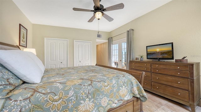 bedroom featuring ceiling fan, two closets, and french doors