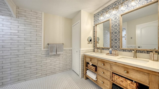 bathroom featuring tile patterned floors, vanity, and tile walls