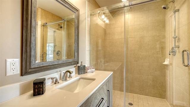 bathroom with vanity and a shower with door