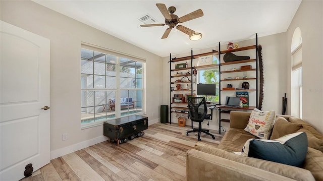 office area with ceiling fan and light wood-type flooring