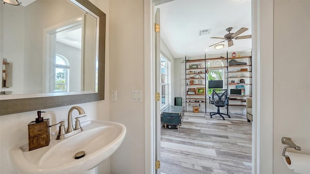 bathroom with hardwood / wood-style floors, ceiling fan, and sink