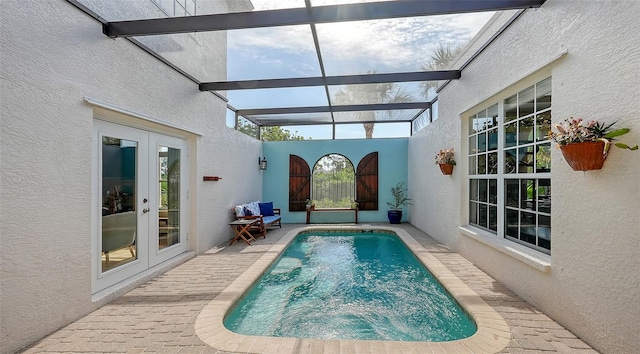 view of swimming pool with french doors