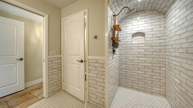 bathroom featuring tile patterned floors and a tile shower