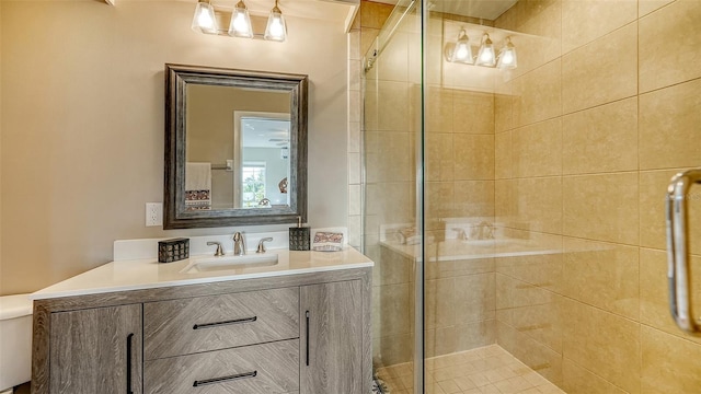 bathroom featuring vanity, toilet, and walk in shower