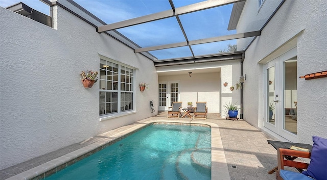 view of swimming pool with a patio area and french doors