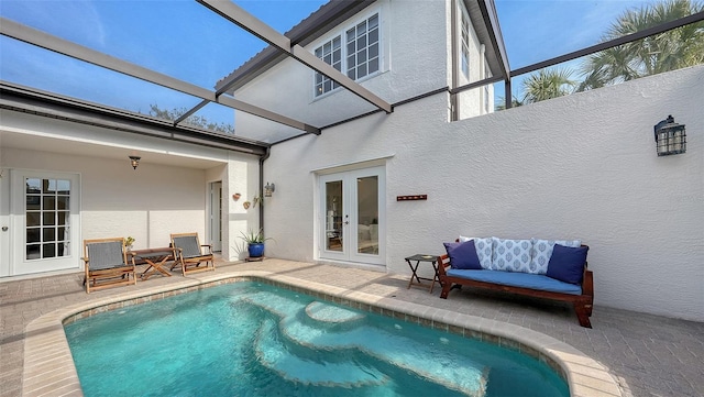 view of swimming pool featuring french doors, a patio, and glass enclosure