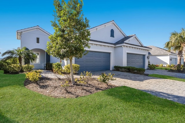 view of front of house featuring a front yard and a garage