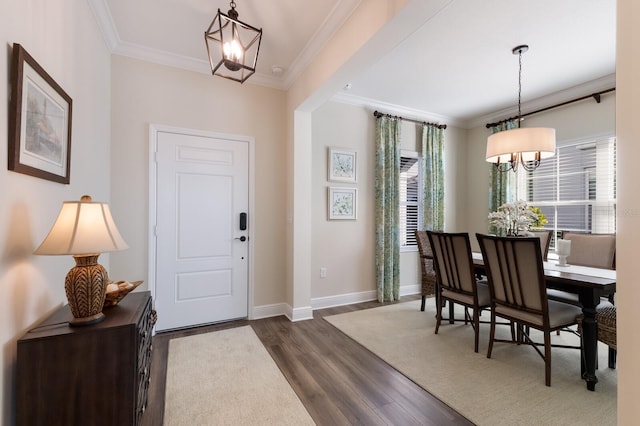 foyer entrance with a chandelier, dark hardwood / wood-style flooring, and crown molding