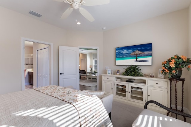 bedroom featuring ceiling fan, ensuite bathroom, and light hardwood / wood-style floors