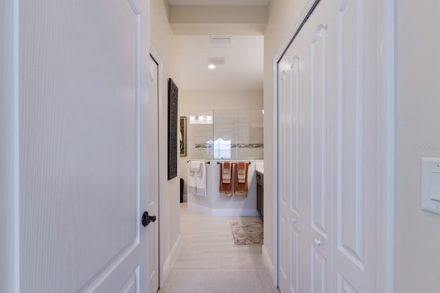 corridor with light tile patterned floors