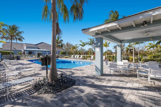 view of pool featuring ceiling fan and a patio area