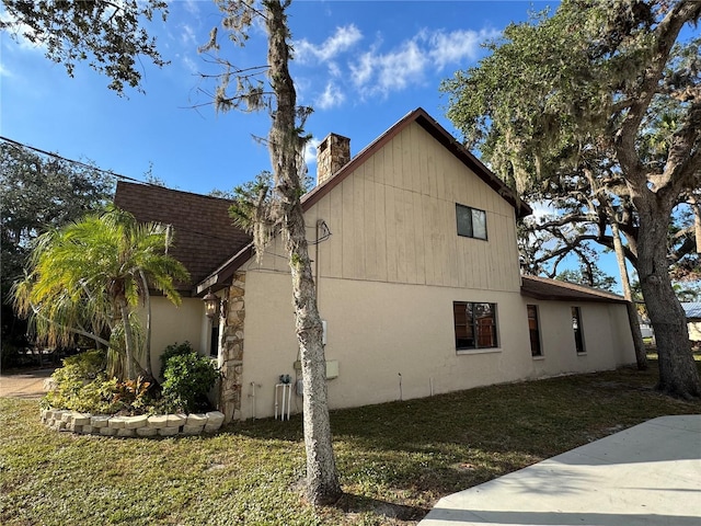 view of side of home with a yard