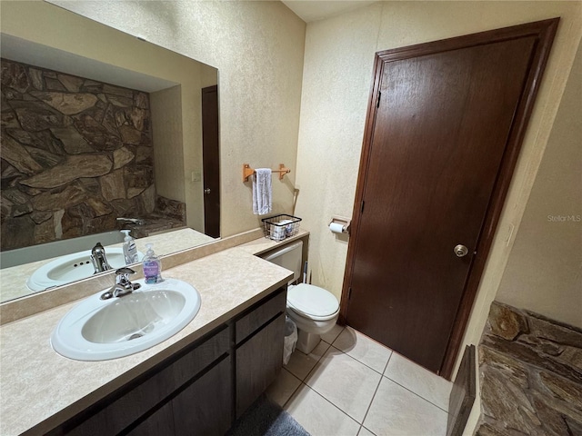 bathroom featuring tile patterned flooring, vanity, and toilet