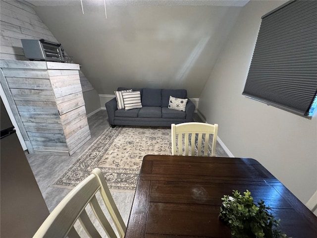 living room featuring a textured ceiling and lofted ceiling