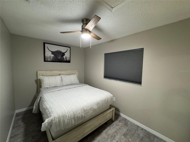 bedroom with ceiling fan, a textured ceiling, and hardwood / wood-style flooring