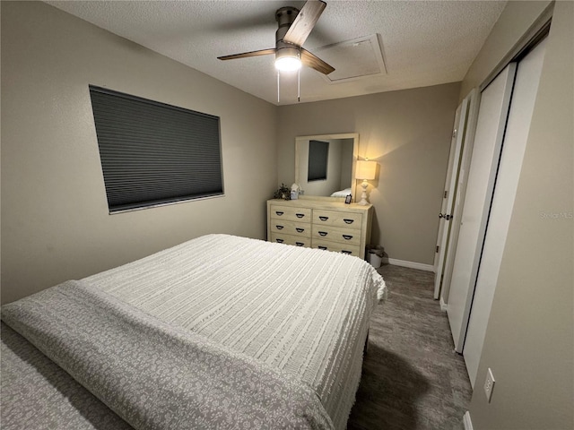 bedroom with ceiling fan, dark carpet, a textured ceiling, and a closet