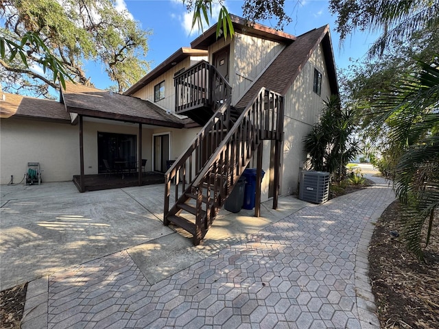 rear view of property with a balcony and cooling unit